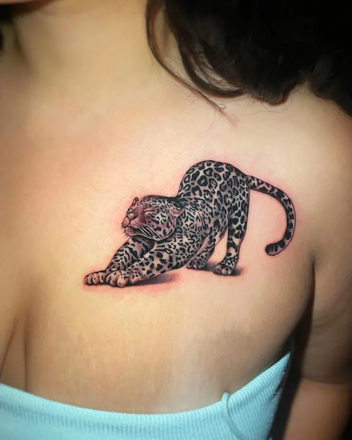 Black and grey tattoo by Dre: leopard, chest