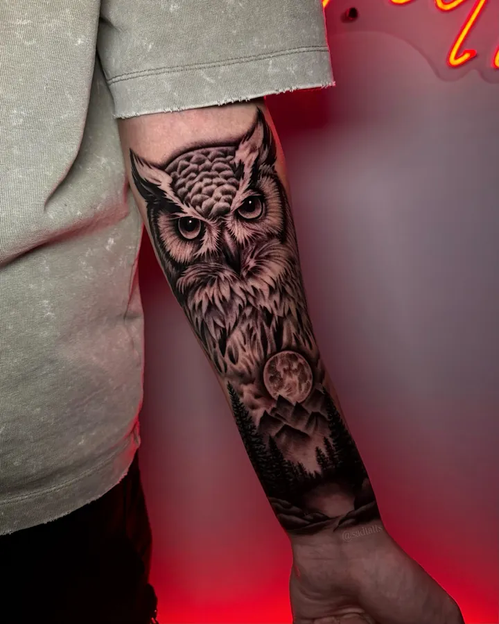 Black and grey tattoo by Dre: owl, forearm