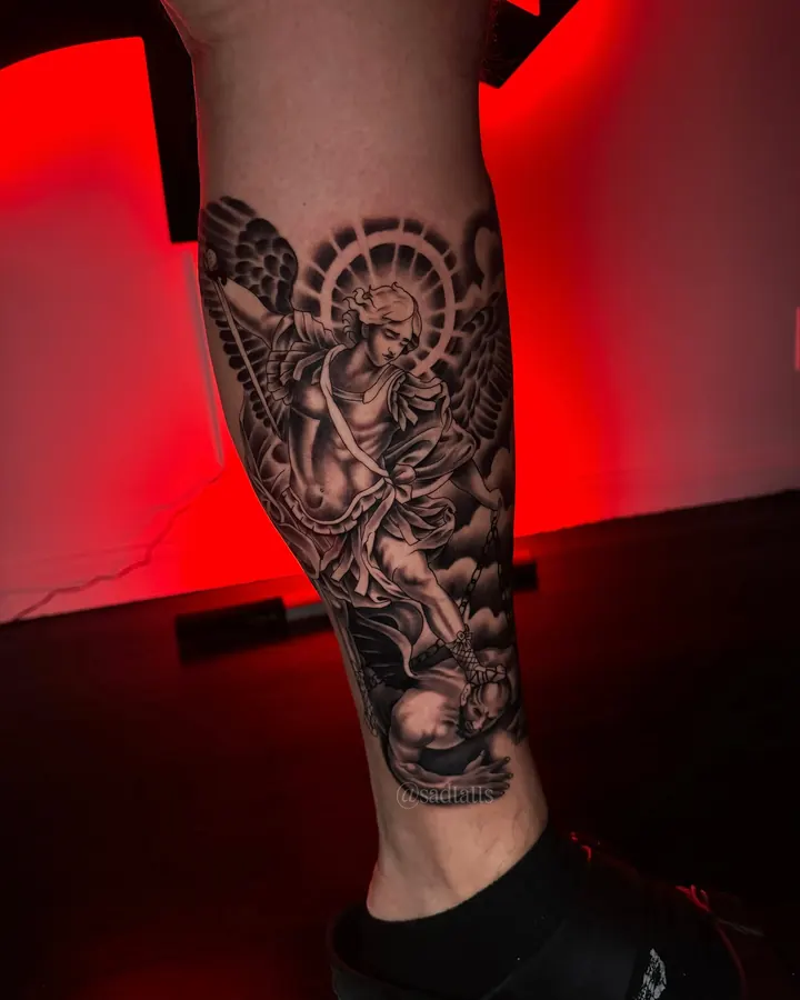 Black and grey tattoo by Dre: angel figure, calf