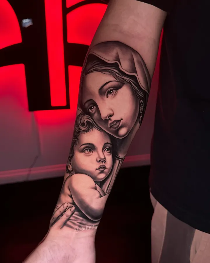 Black and grey tattoo by Dre: Virgin Mary and child, forearm