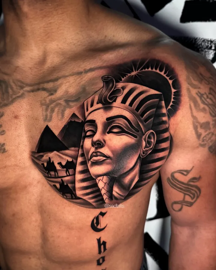 Black and grey tattoo by Dre: pharaoh woman and pyramids, chest