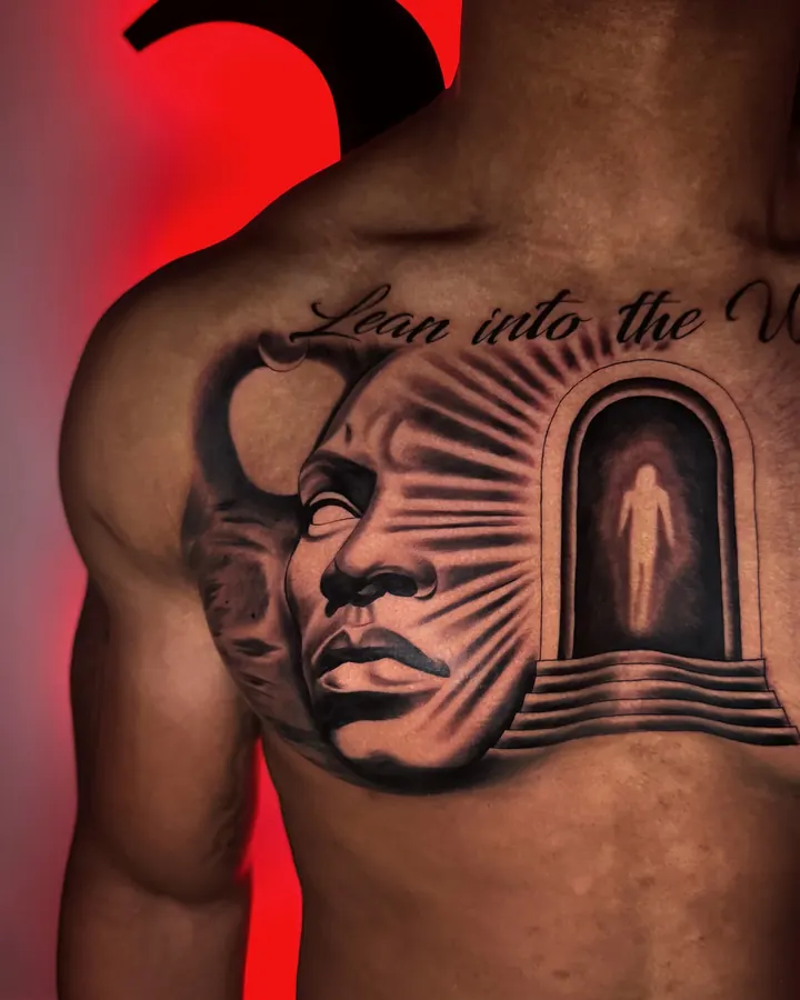 Black and grey tattoo by Dre: Lean into the Unknown, chest (left side)