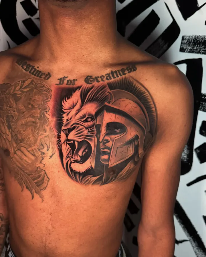Black and grey tattoo by Dre: lion and spartan helmet, chest
